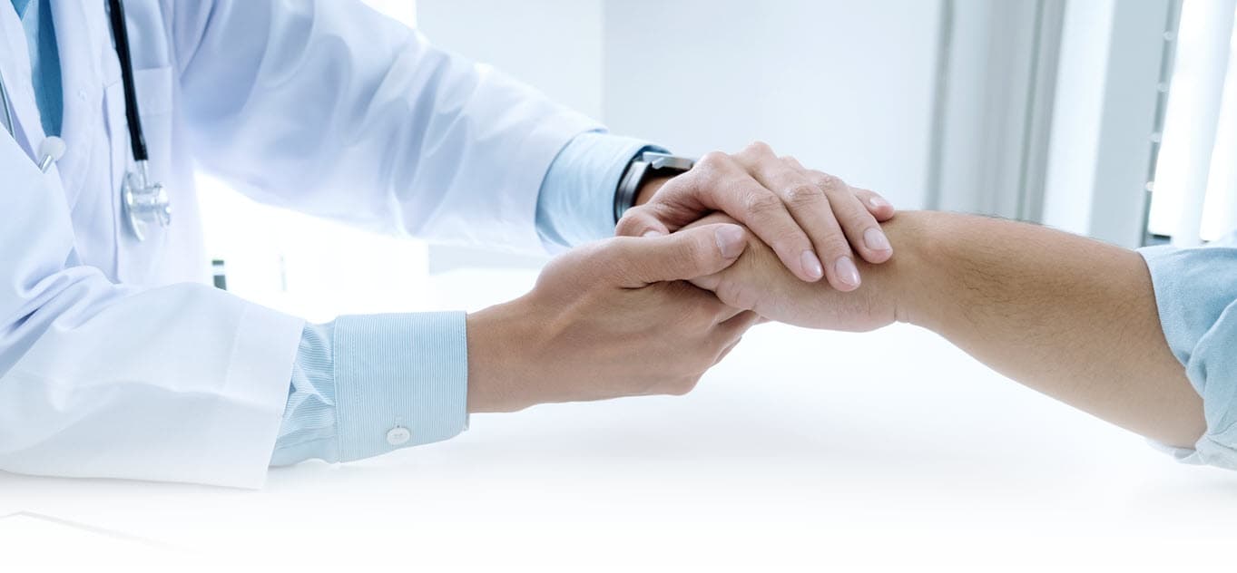 Adult patient and Cayman Medical clinician reviewing health screening results together in a bright boutique consultation room